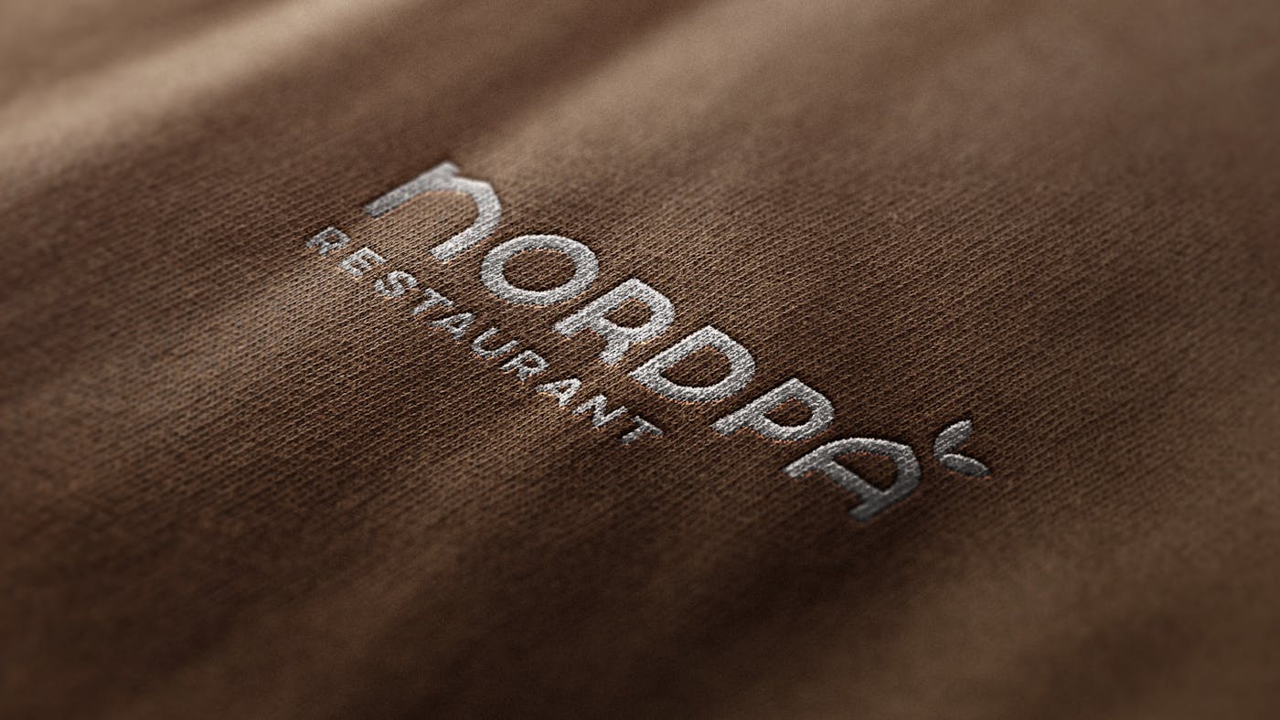 Nordpå restaurant logo oker tekstil